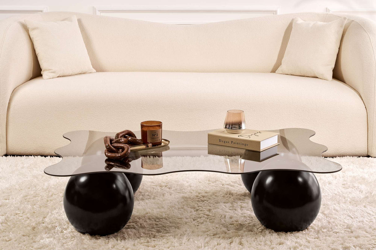 Golvende salontafel grijs getint glas zwarte bolpoten Noxa 120x80 cm